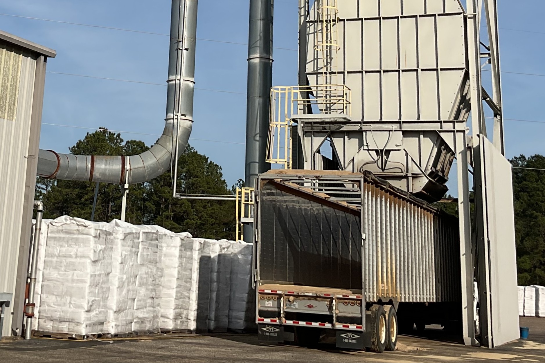 Tractor-trailer loading under silo at Patterson Wood Products facility